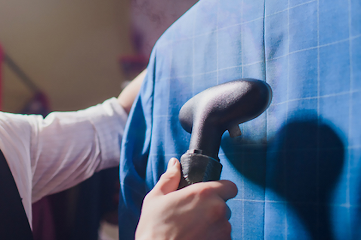 Ironing of a men's checked suit with steam