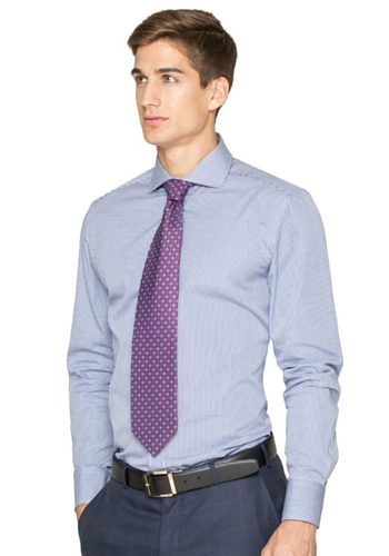 man with a custom light blue dress shirt and purple tie