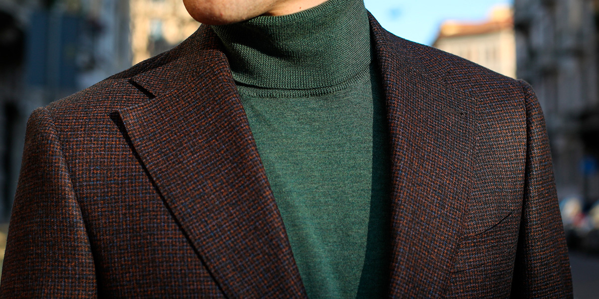 Details of a Lanieri tailored brown burgundy jacket with green turtleneck sweater