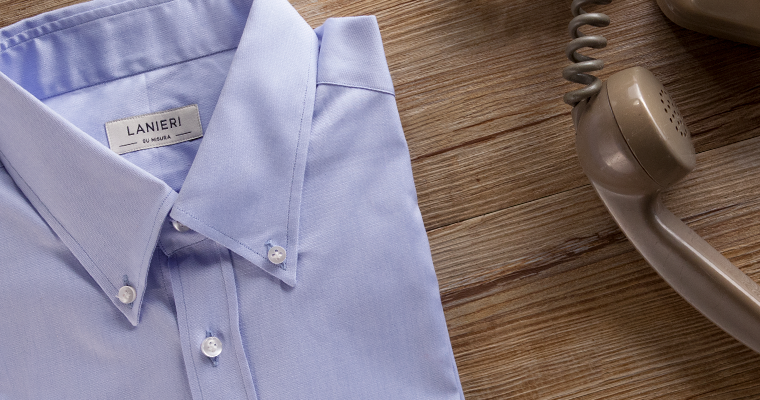 Lanieri's custom blue dress shirt with a button-down collar folded up next to an old '70s phone