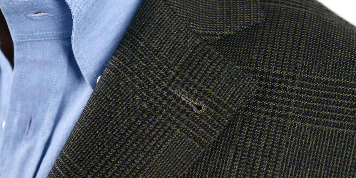 Classic notched lapels detail on a two-button Prince of Wales jacket