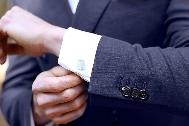 Cuff detail for cufflinks on white tailored shirt for groom