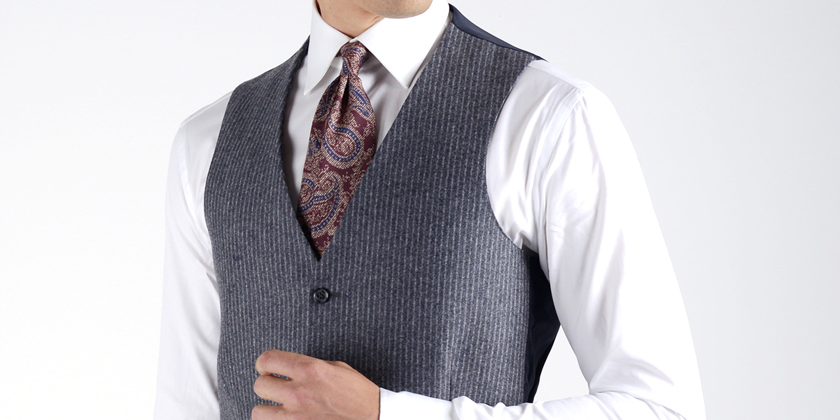 Gray pinstriped waistcoat worn on a white shirt and burgundy patterned tie